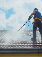 Man cleaning a weathered tile roof. Blue sky, Man cleaning a weathered tile roof. Blue sky, High pressure cleaning. outdoor. Created by ai